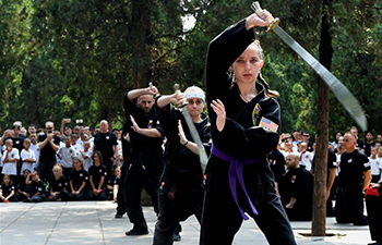 American Kungfu enthusiasts perform martial arts with local monks at Shaolin Temple